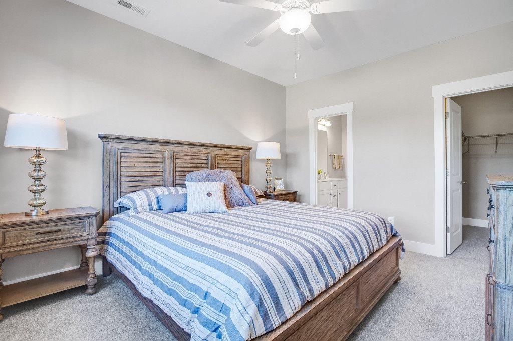 Two and Three Bedroom Apartments in Wilmington, NC - Myrtle Landing Master Bedroom with Carpet Floors, Ceiling Fan, and Attached Bathroom and Walk-in Closet